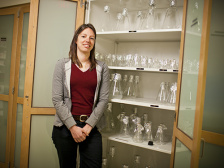 a person stands next to a cabinet of flasks